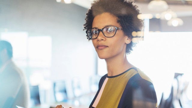woman with glasses in meeting room