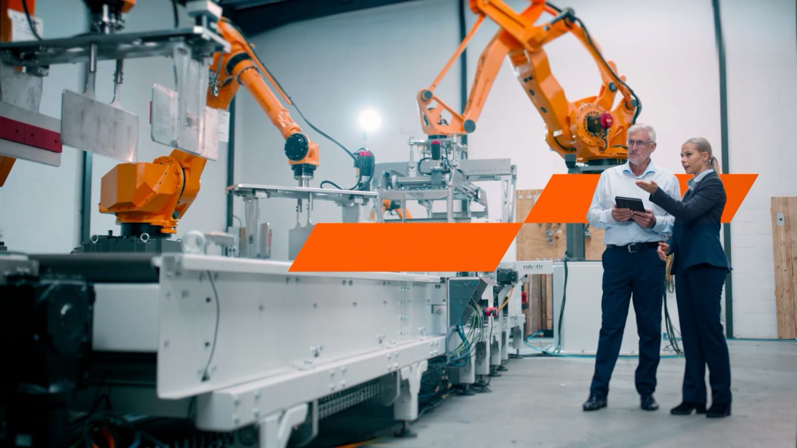 Two people standing in industrial mechanical warehouse