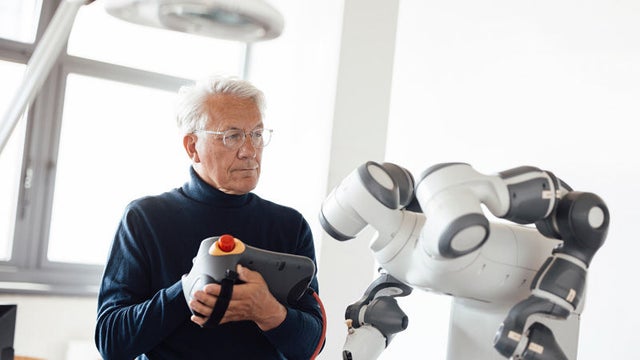man looking at robot