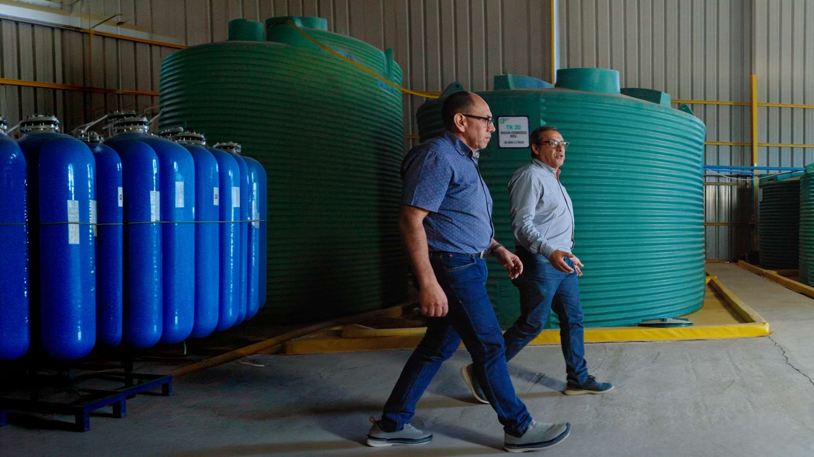 Two men walking in a factory
