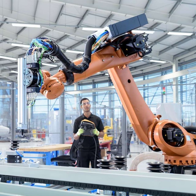 A man operating an industrial robot